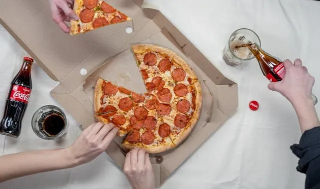hands taking slices from a pizza box for can you recycle pizza boxes hands taking slices from a pizza box for can you recycle pizza boxes