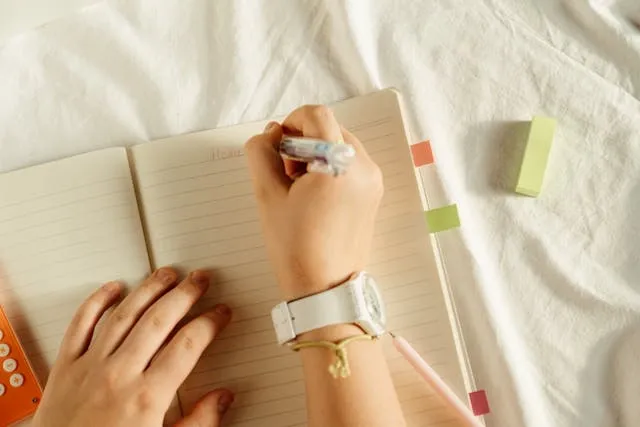 a person preparing to write in a notebook for what is a gel pen a person preparing to write in a notebook for what is a gel pen