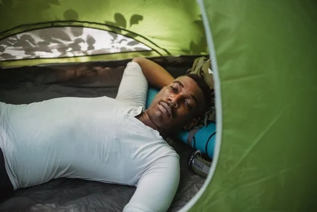 a man in a tent for how to attach sleeping bag to backpack a man in a tent for how to attach sleeping bag to backpack