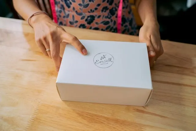 a person holding a white branded box for how many giveaways to order for a trade show