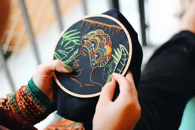 someone embroidering on black fabric for heat transfer vs embroidery someone embroidering on black fabric for heat transfer vs embroidery