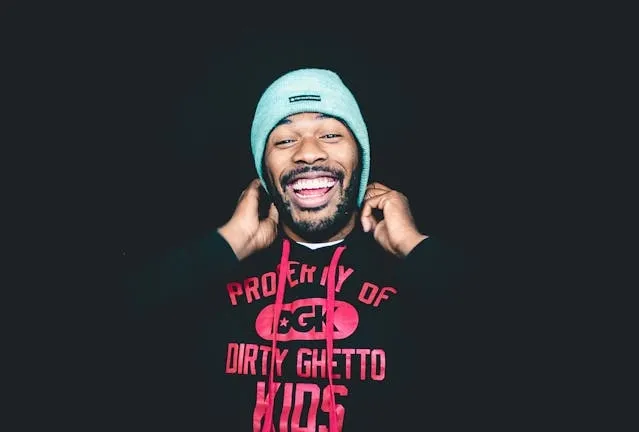 a man wearing a black shirt and blue beanie for heat transfer vs embroidery a man wearing a black shirt and blue beanie for heat transfer vs embroidery