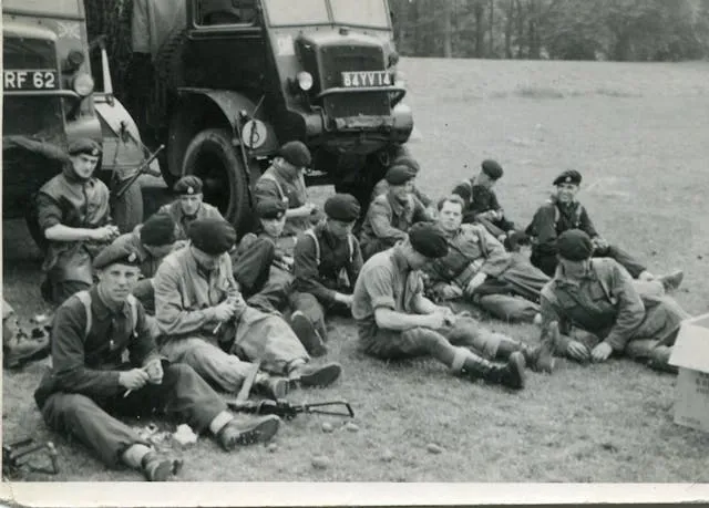 a black and white photo of soldiers resting by trucks for world war 2 wwii army patches identification a black and white photo of soldiers resting by trucks for world war 2 wwii army patches identification