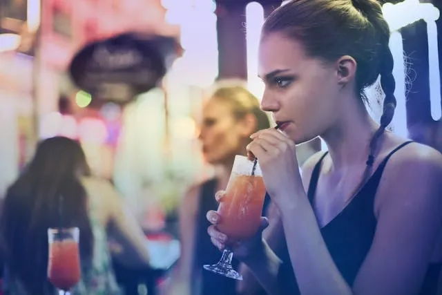 a woman sipping a cocktail for starting a cocktail business a woman sipping a cocktail for starting a cocktail business