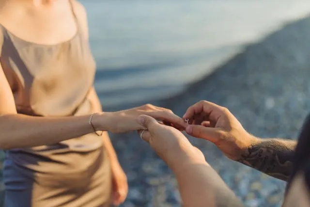 a man and woman holding hands by some water for private proposal ideas a man and woman holding hands by some water for private proposal ideas