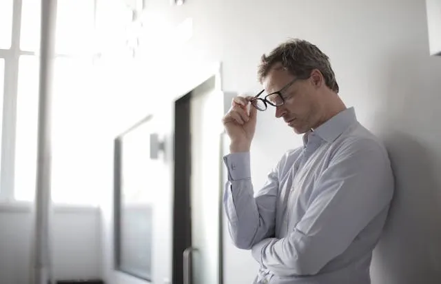 a man holding black eyeglasses for how to journal for mental health a man holding black eyeglasses for how to journal for mental health