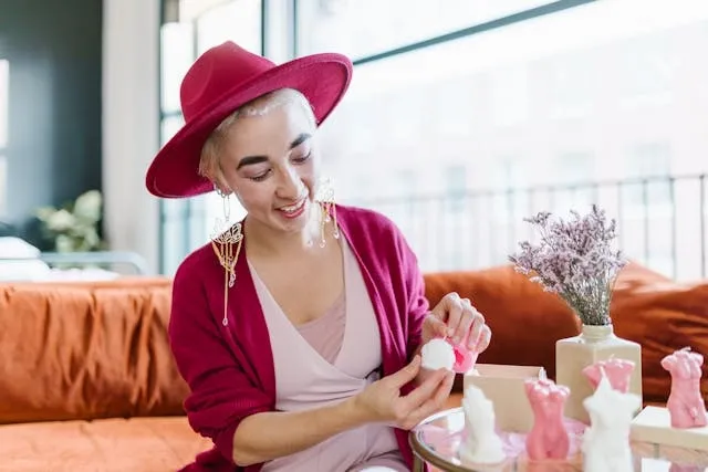 a woman adding decorations to a table for dining table decor ideas