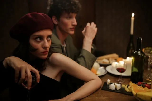 a man and woman at a dining table for french table setting