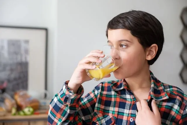 a child drinking fruit juice for felt coasters diy