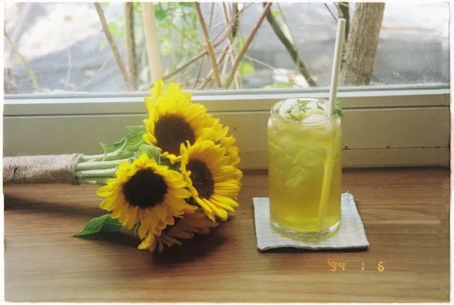a cocktail beside a bunch of flowers for felt coasters diy