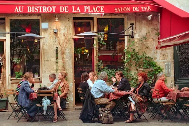 people dining outside a french bistro for french table setting