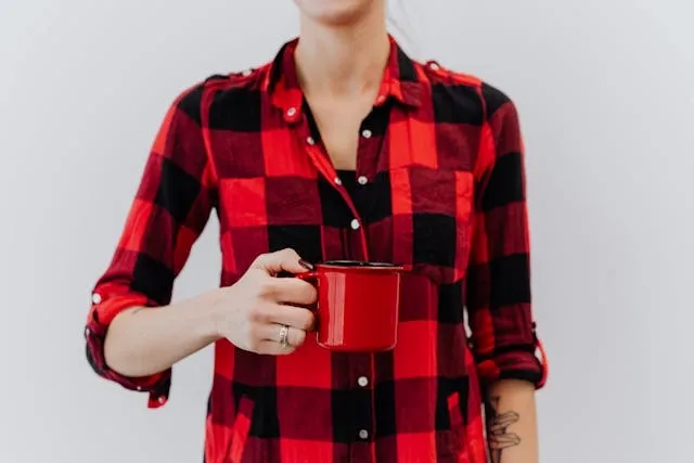 a person holding a red mug for felt coasters diy