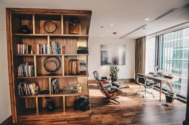 a rustic wooden bookshelf in an office for office wall decor ideas