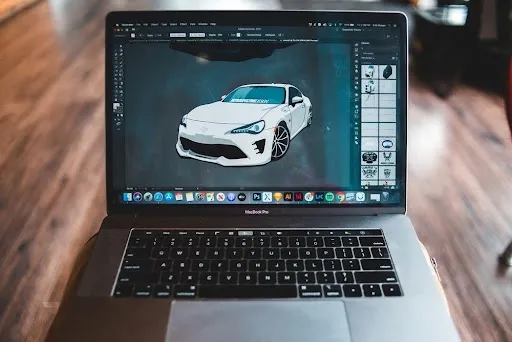 Vector design software on a laptop used to prepare SVG files for laser engraved coasters