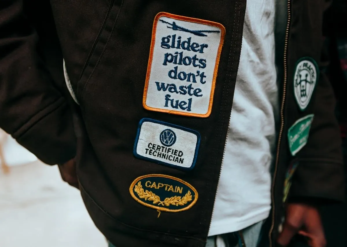 Close-up of finished DIY patches sewn onto a jacket sleeve, showing the completed look of homemade embroidered and chenille patches.jpg Close-up of finished DIY patches sewn onto a jacket sleeve, showing the completed look of homemade embroidered and chenille patches.jpg