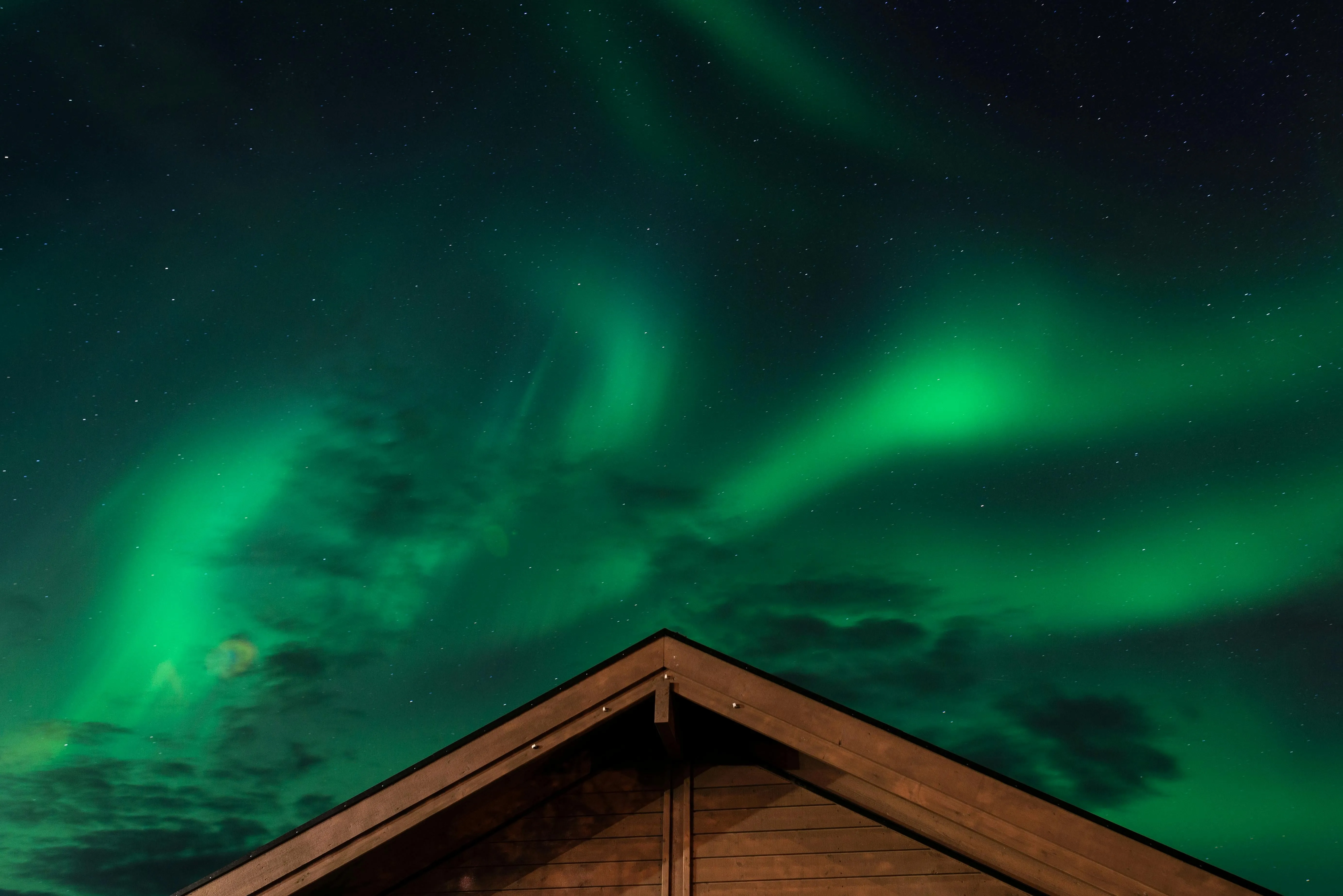 a brown house under the aurora borealis for are neon lights plasma