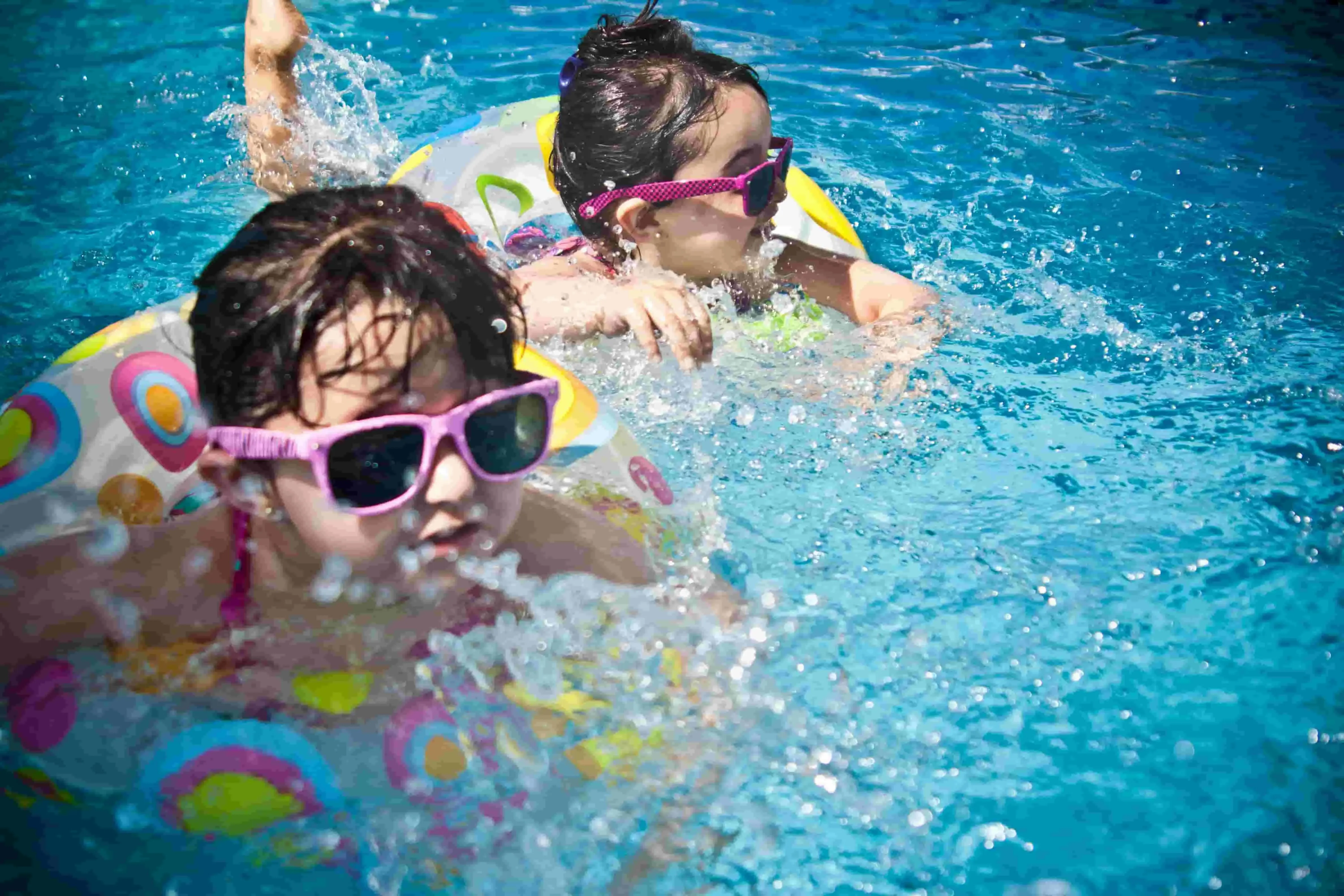 two children splashing in the pool for pool party decorations
