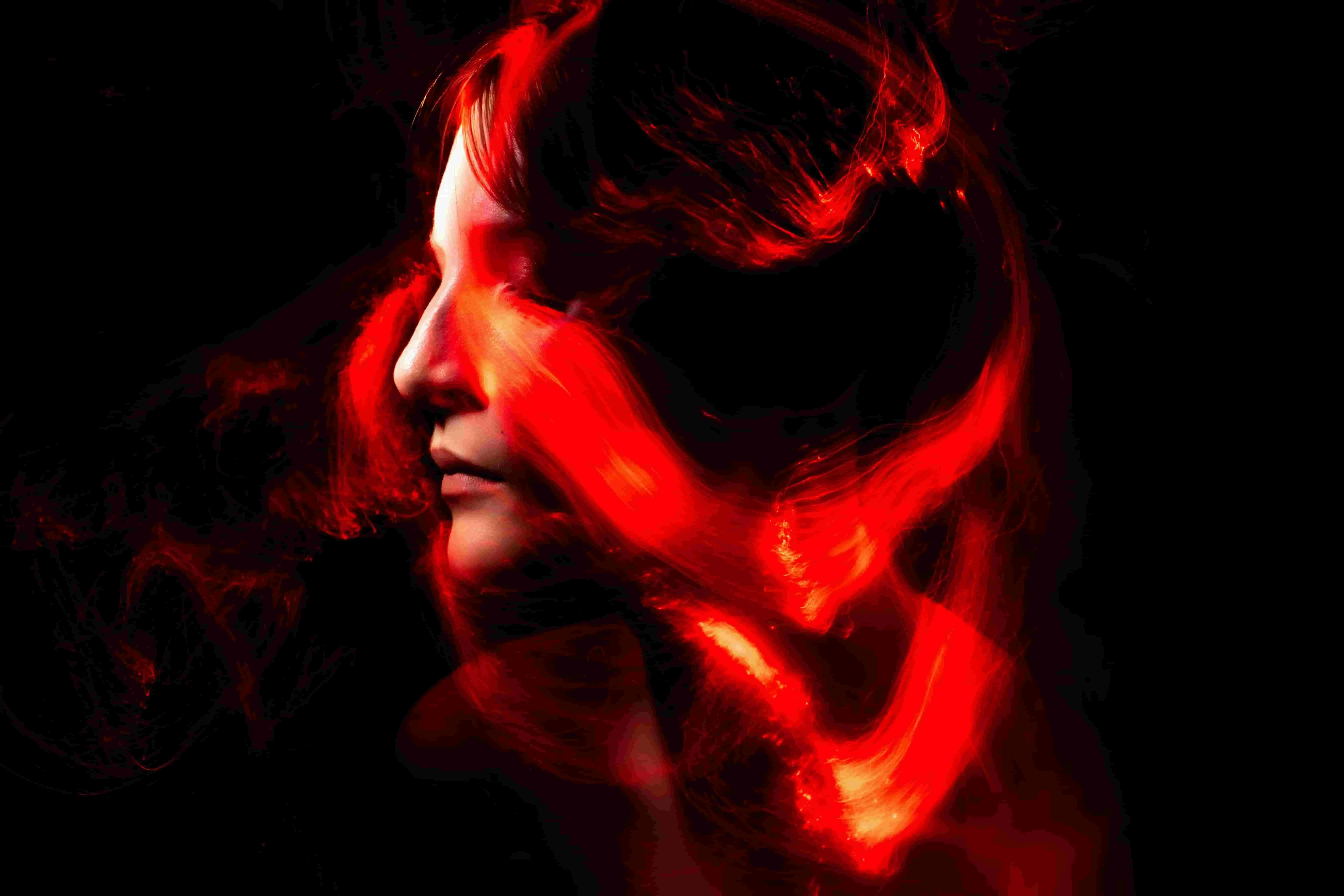 a woman with red light around her head for are neon lights plasma