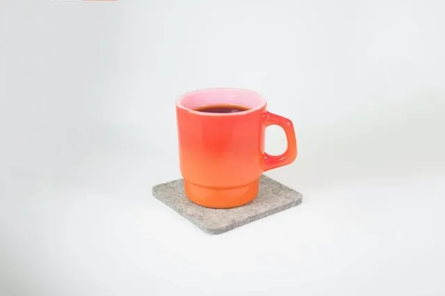 a mug on a coaster for what to put on bottom of coasters