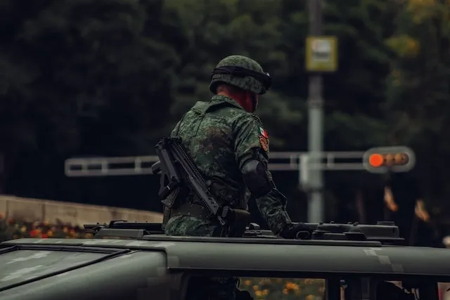 a soldier in full uniform with patches for how to sew on military patches by hand