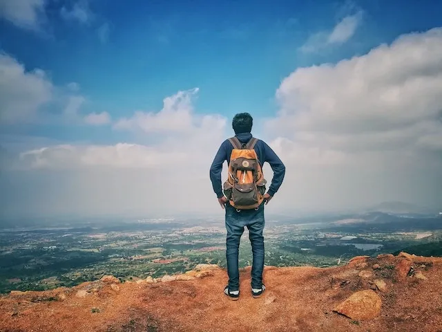 a man wearing a backpack for how to iron on a patch to a backpack