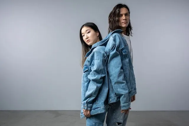 a man and woman sharing a denim jacket for how to put patches on denim jacket