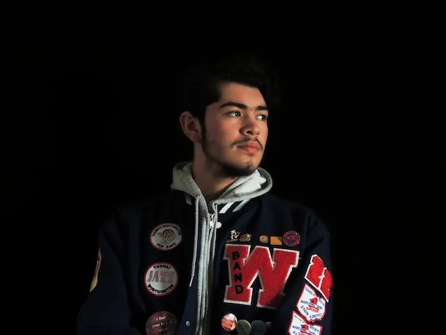 man wearing a letterman jacket for how to put patches on letterman jacket