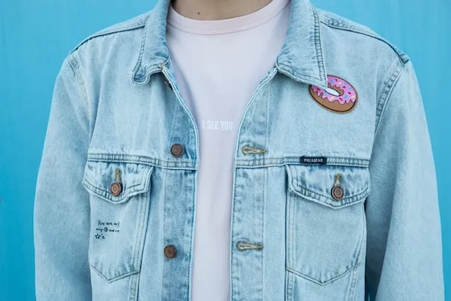 a person wearing a denim jacket for how to put patches on denim jacket