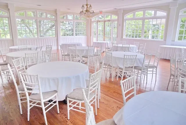 a room full of covered circular tables for round tablecloth sizes