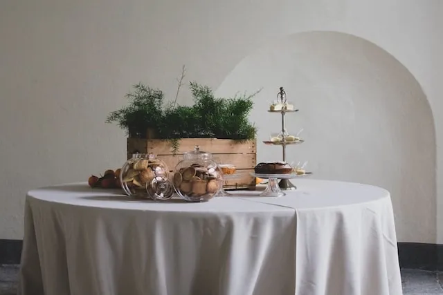 table setting with a white tablecloth for how to get wrinkles out of polyester tablecloths