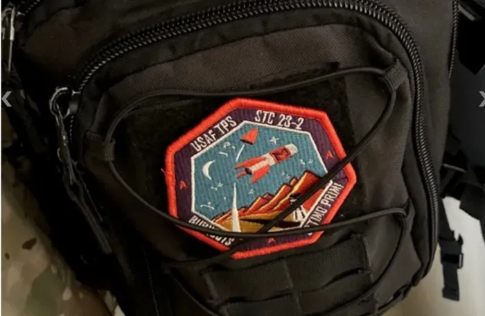 a patch attached to a backpack for how to iron on a patch to a backpack