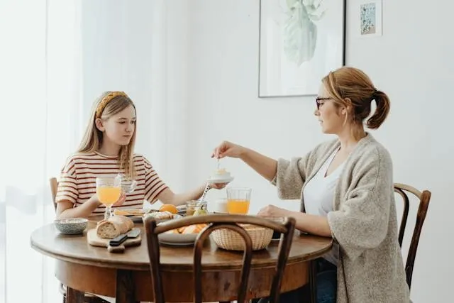 women dining at a round table for can a rectangle tablecloth fit a round table