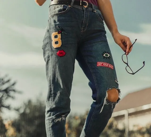 a woman wearing patched jeans for how to sew patches onto jeans