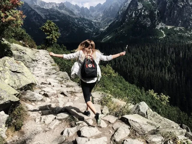 a woman with a backpack in the wilderness for patches on backpack