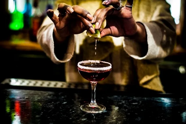 a person mixing a cocktail for cocktail table linen size