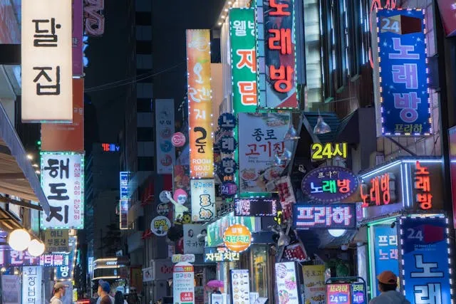 a street filled with neon signs for can neon signs be used outdoors