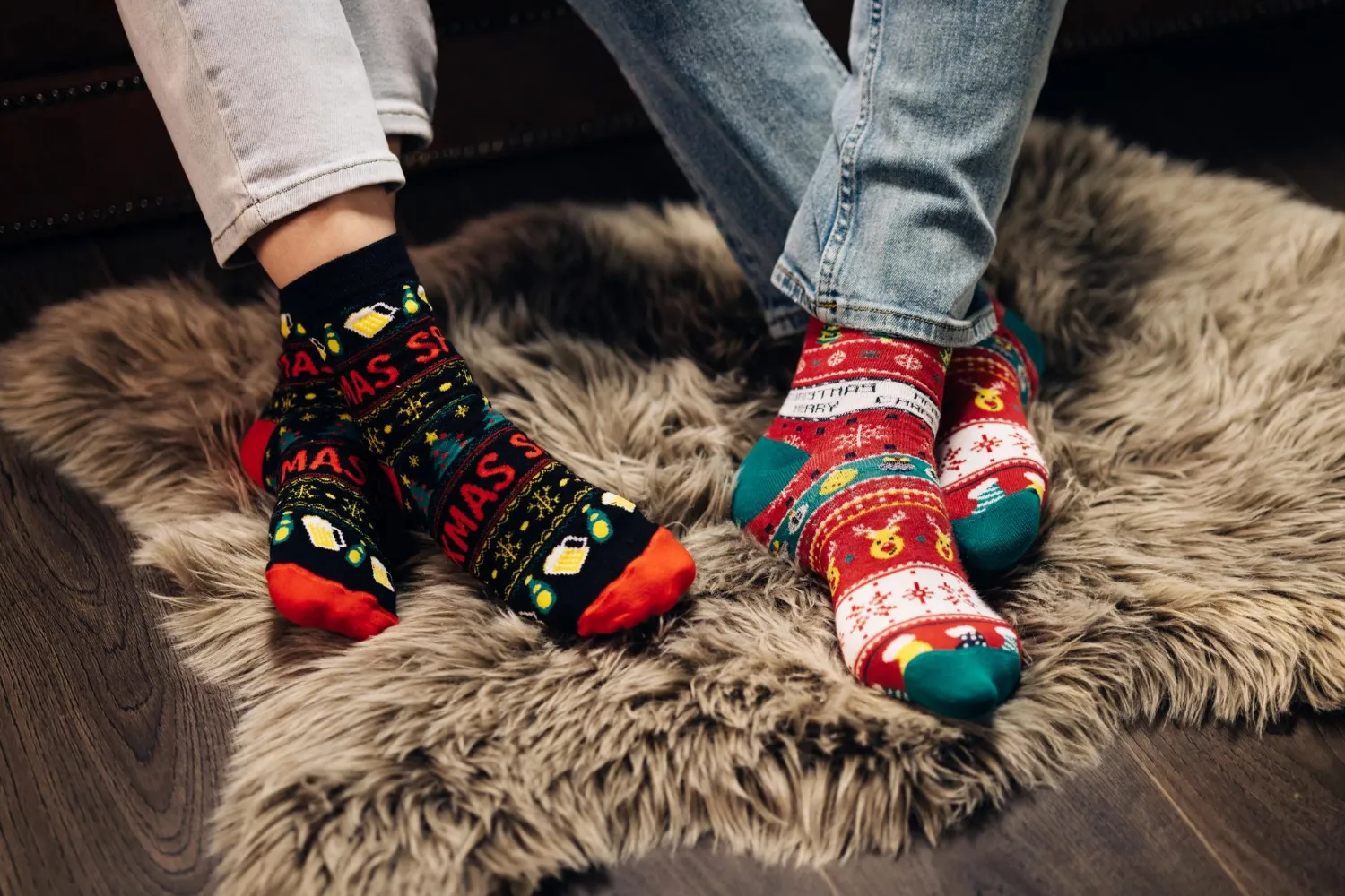 Feet in colorful wool socks legs in winter christmas socks in cozy home interior christmas socks two