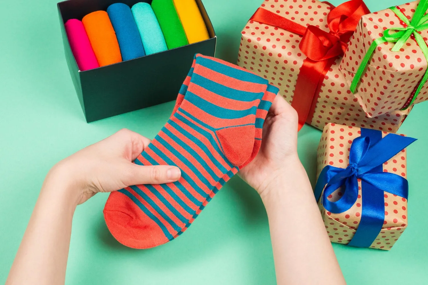 Colorful collection of cotton socks as a gift in woman hands gift