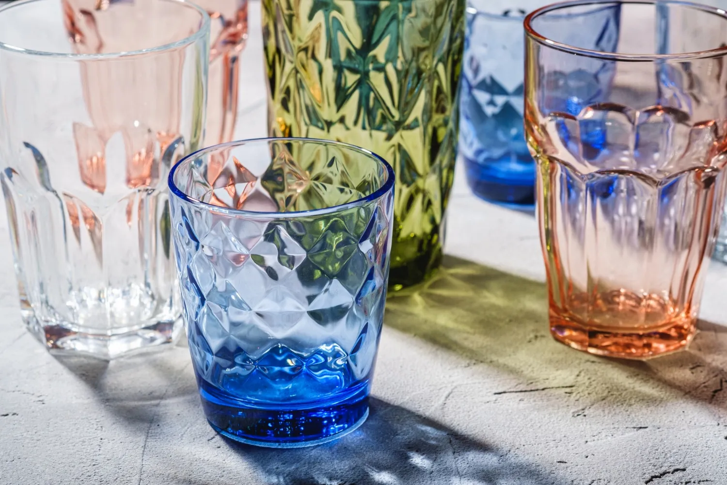 Colorful faceted and geometric drink glasses