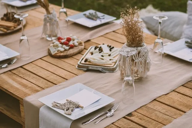 a rustic table setting with runner and accessories for how to decorate with table runners