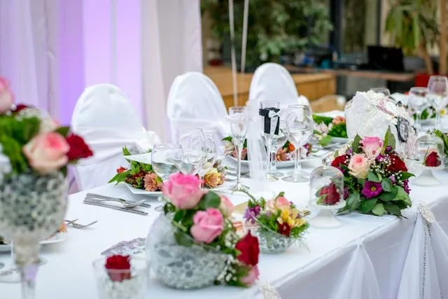an elegant table setting with white cloth and flowers for are tablecloths out of style