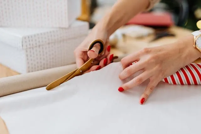 cutting gift wrap with scissors for how to wrap coasters