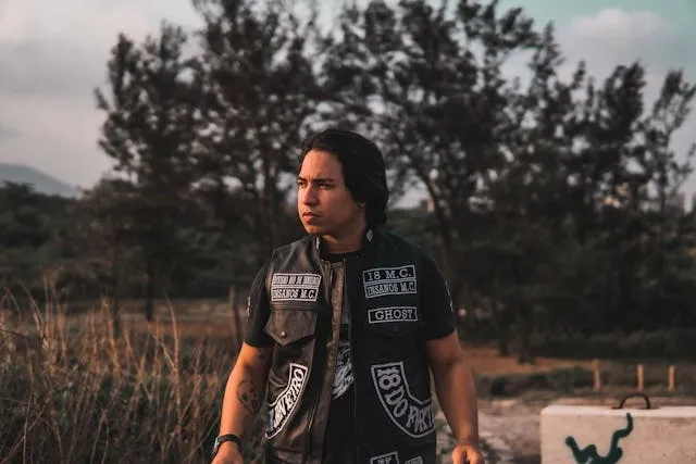 a man wearing a leather motorcycle vest with patches for iron on patches on leather