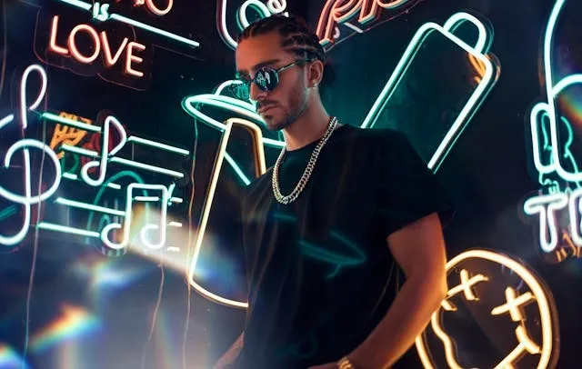 a man surrounded by colorful neon signs for neon sign repair