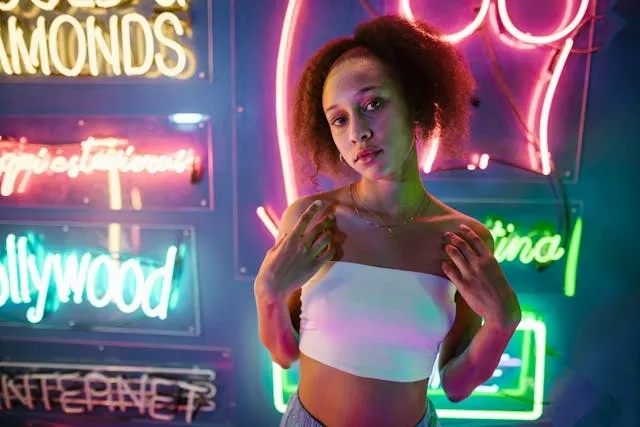 a woman standing with neon signs for neon sign repair