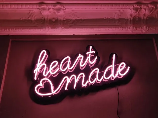 a small, pink neon sign that says heart made for neon sign flickers but won’t turn on