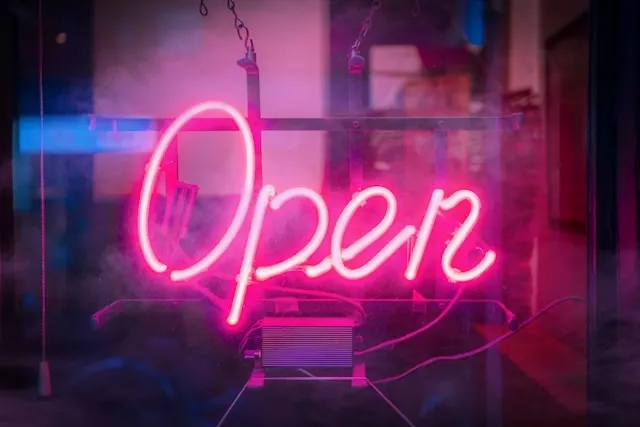 a vibrant open neon sign for how do neon lights work