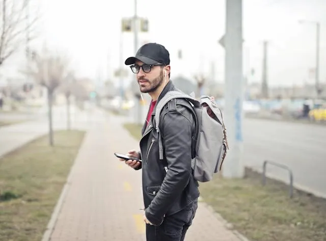 a man carrying a backpack by the roadside for best backpacks for patches