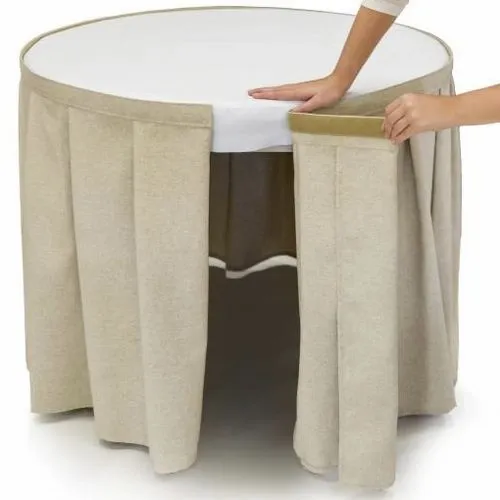 a table skirt being applied to a round table for how to attach table skirt without clips