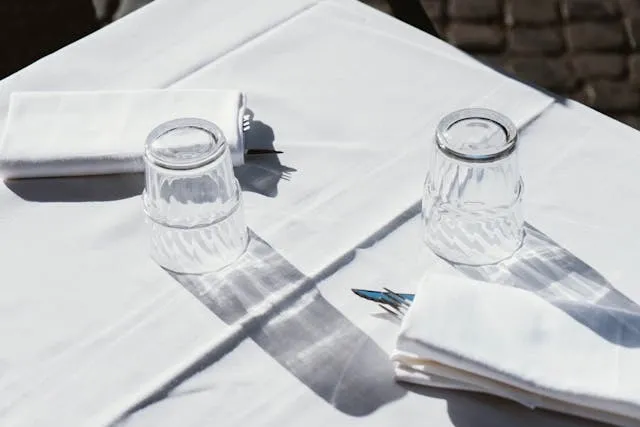 a white tablecloth on a table for how to get mold out of tablecloths